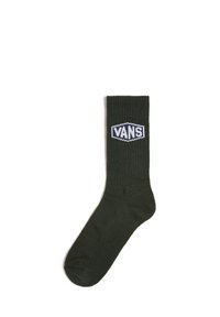 Olive green cotton crew sock with ribbed texture and white "VANS" logo patch on the front. Standard length with reinforced toe.