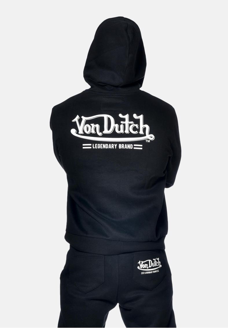 Sweat à capuche noir avec le logo blanc "Von Dutch Legendary Brand" au dos. Présente une coupe décontractée et est fabriqué en tissu doux.