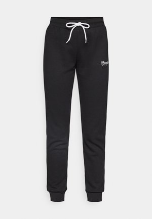 Black sweatpants made of soft, textured fabric. Features a white drawstring, cuffed ankles, and a small embroidered logo on the thigh.