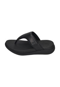 Sorte flip-flop sandal med en teksturert gummisåle, flat fotbed og et design med én stropp som har en thong-stil overdel.