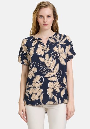 Blumen Kurzarmbluse in Marineblau mit cremefarbenem botanischen Druck. Hat einen Schalkragen und eine lockere Passform. Weicher Stoff.