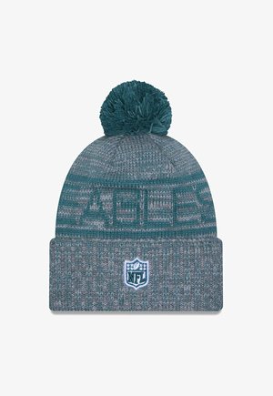 Knit beanie in teal and gray with a textured pattern and a pom-pom on top, featuring an NFL logo patch on the cuff.