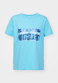 Light blue cotton t-shirt featuring a folded graphic design in dark blue text. Short sleeves and a crew neck. Smooth texture, casual fit.