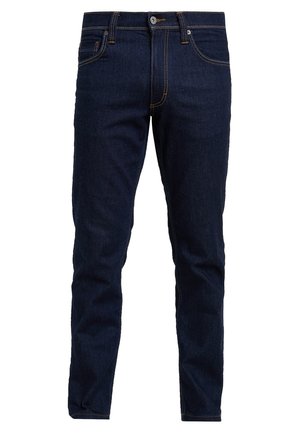 Jeans din denim de culoare albastru închis, cu o croială slim, având cusături contrastante, cinci buzunare și un sistem de închidere clasic cu nasturi.