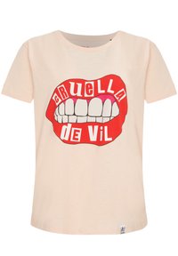 Růžovo-oranžové tričko s krátkým rukávem, které zobrazuje grafický potisk červených rtů s bílými zuby a nápisem "CRUELLA DE VIL" tučným písmem.