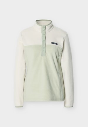 Pika varrukaga fliisist tõmblukk-kampsun nööbitava kõrge kraega, kreemikas ülaosa ja varrukad, heleroheline alaosa ja Columbia logo rinnal.