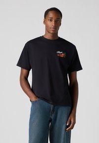 Black cotton t-shirt featuring a front left embroidered design with the word "Fresh" and vegetables. Crew neck and short sleeves.