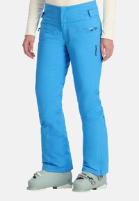 Blaue isolierte Skihosen mit einem eleganten Design, Reißverschlusstaschen und schmalem Schnitt. Zu den Merkmalen gehören eine hohe Taille und verstärkte Stoffakzente.