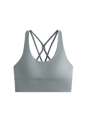 Sportovní podprsenka ve světle šedé tkanině s hladkým povrchem, s designem překříženého zadního dílu a širokým, podpůrným pásem na spodní části.