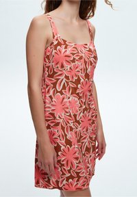 Floral dress with thin straps, featuring a brown background and vibrant pink and white floral patterns. Lightweight fabric with a relaxed fit.