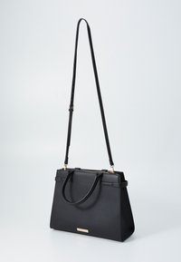 Sac à main noir structuré en matériau synthétique texturé. Doté de deux poignées, d'une longue sangle réglable et d'un accent en métal doré.