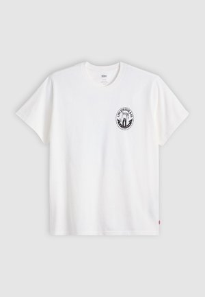 White cotton t-shirt with short sleeves, round neck, and a black circular logo on the left chest featuring a stylized design.