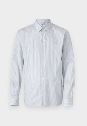 Dryžuota ilgomis rankovėmis marškiniai šviesiai mėlynos ir baltos spalvos medvilnės mišinyje. Funkcijos mygtukų uždarymas, klasikinė apykaklė ir mažas išsiuvinėtas logotipas ant krūtinės.