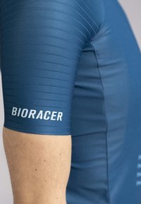 Blue cycling jersey with a fitted design. Textured fabric featuring horizontal stripes, includes "BIORACER" logo in white on the sleeve.