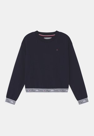Sweat-shirt court bleu marine avec encolure ronde, manches longues et bande blanche à l'ourlet affichant la marque "Tommy Hilfiger".