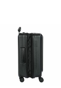 Valigia nera rigida con superficie texture, chiusura a zip, maniglia laterale e quattro ruote. Design compatto e rettangolare per il viaggio.