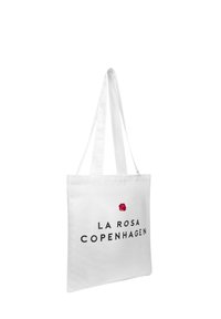 Bolso tote blanco de tela, con el texto negro "LA ROSA COPENHAGUEN" y un pequeño gráfico de rosa roja en la parte frontal. Con asas planas.