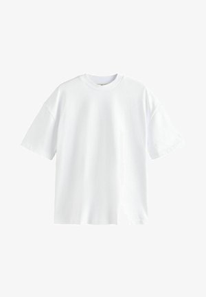 T-shirt en coton blanc à manches courtes, col rond et coupe décontractée. Texture lisse, sans motifs ni designs visibles.