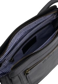 Grey leather bag with a smooth texture, featuring a striped blue and white fabric lining, gold zipper hardware, and multiple interior pockets.