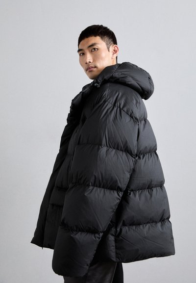 Chaqueta acolchada negra con capucha, que presenta un diseño acolchado, un relleno grueso y una textura suave, mostrada en un ángulo con un fondo neutro.