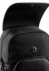 Black backpack with a durable fabric exterior, rounded shape, zipper closure, and a flap featuring a button snap for added security.