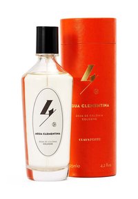 Kölnisch Wasser in einem klaren Glasdesign, mit schwarzem Deckel und weißem Etikett, auf dem "Agua Clementina" steht. Begleitet von einer orangefarbenen zylindrischen Box.