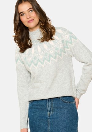 Gray sweater with a light blue and white geometric pattern at the yoke, featuring a high neck and ribbed cuffs. Worn over a denim skirt.