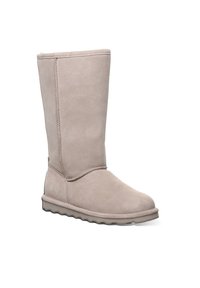 Beige Wildlederkniehohe Stiefel mit runder Zehenform, weicher Textur, sichtbaren Nähten entlang der Nähte und einer Gummisohle mit Profil für besseren Halt.