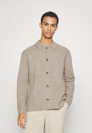 Brown, button-up jacket with a collared neckline, two front pockets, and a textured fabric. Features large buttons and a relaxed fit.