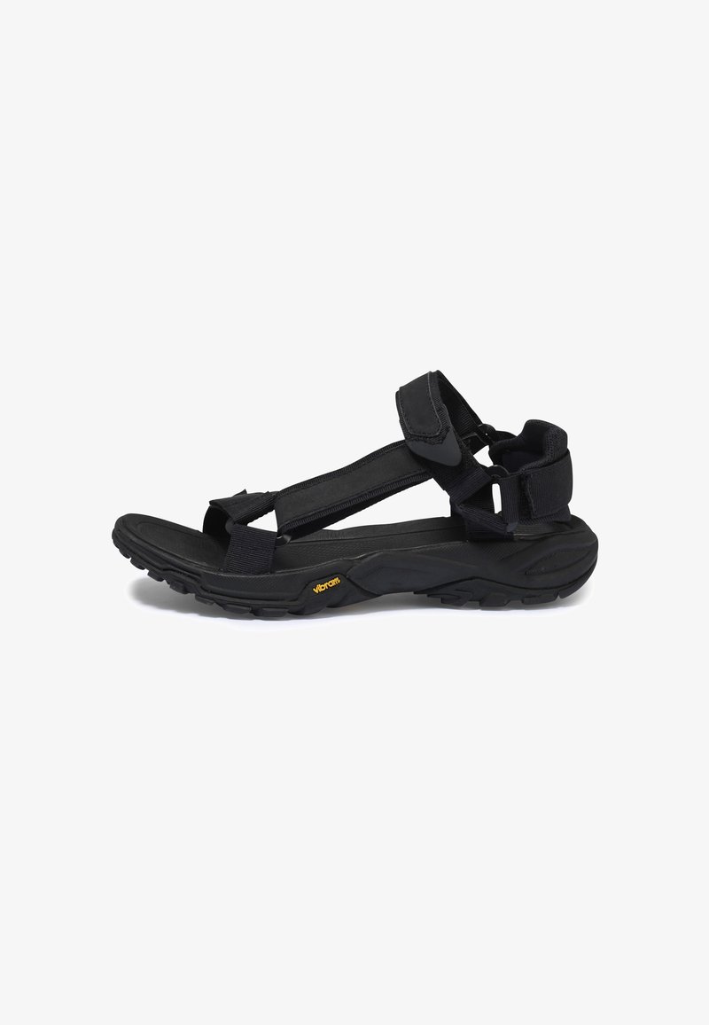 Černé turistické sandály s nastavitelnými popruhy, s texturovanou podrážkou a logem Vibram. Mají pevný design pro pohodlí a trvanlivost.