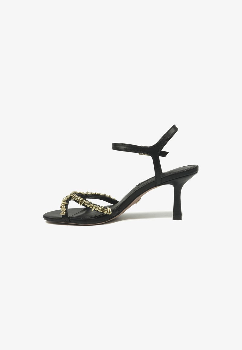 Black high-heeled sandal with thin straps, ankle buckle, and gold-toned irregular bead decoration on front straps.