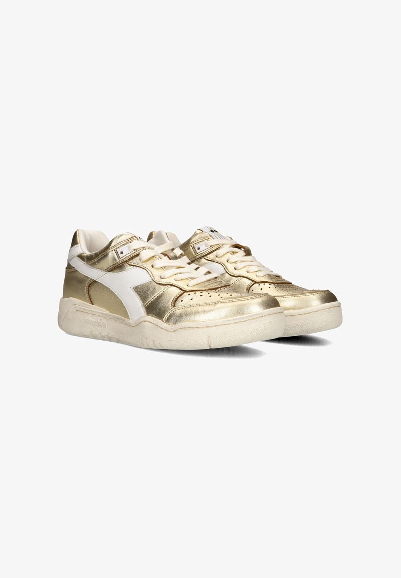 Gold and white sneakers with a shiny metallic finish, featuring a perforated toe box, flat laces, and a textured rubber sole.