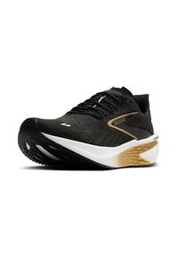 Zapatilla deportiva negra con un upper texturizado, acentos dorados, una entresuela blanca acolchada y una suela de goma negra con diseño.