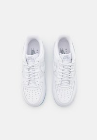 Sneakers Nike Air Force 1 bianchi con tomaia in pelle liscia, punta perforata e collo imbottito; presentano lacci bianchi e suola in gomma testurizzata.