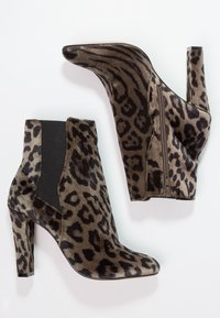 Botas de tobillo con estampado de leopardo y acabado de tela, que cuentan con una punta afilada, tacón de aguja de 5 pulgadas y paneles laterales elásticos para facilitar su uso.