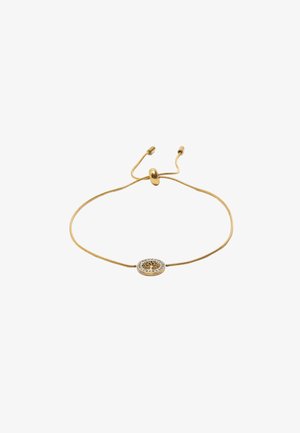 Złota regulowana bransoletka z okrągłym zawieszką z motywem drzewa otoczonym małymi, przezroczystymi kryształami na gładkim pasku.