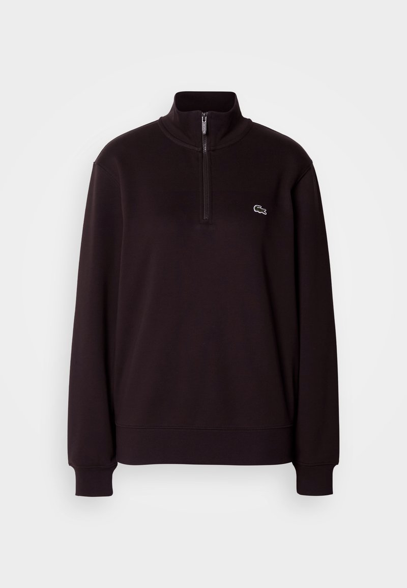 Sweat-shirt noir à col zippé en tissu doux, avec manches longues et petit logo sur la poitrine. Design simple avec poignets côtelés.