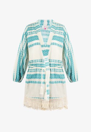 Könnyű, tejszínszínű ruhadarab türkiz törzsi mintákkal, V-kivágással, hosszú ujjakra és megkötős derékkal. Díszes rojtok találhatóak az alján.