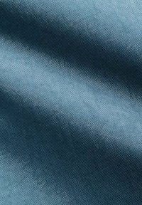 Υφασμα με υφή σε σκούρο μπλε χρώμα, που διαθέτει ένα διακριτικό υφαντό σχέδιο με απαλό και ελαφρώς γυαλιστερό φινίρισμα.