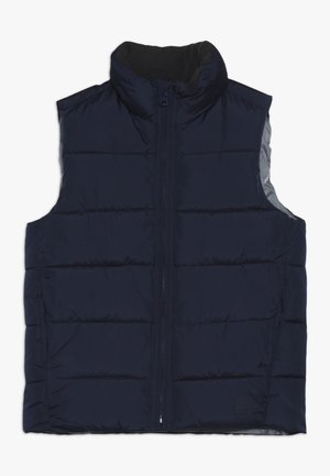 Gilet imbottito senza maniche blu scuro con collo alto e chiusura frontale con zip su sfondo bianco semplice.