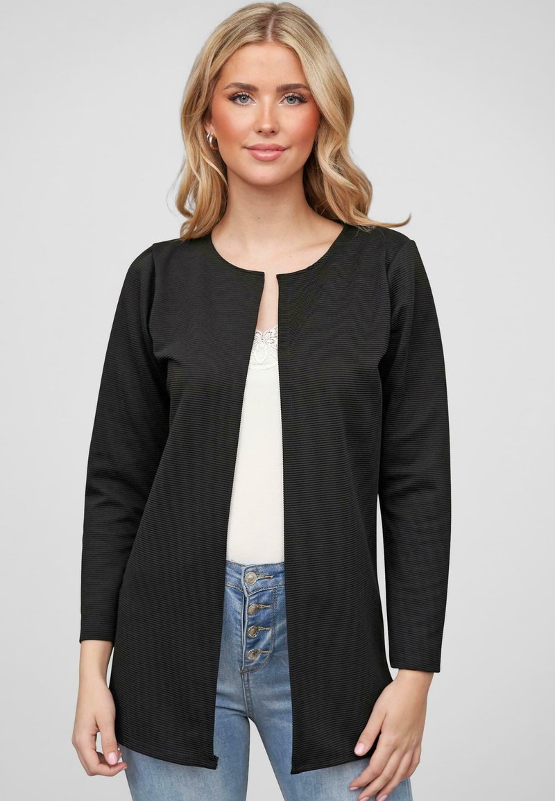 Zwarte geribde cardigan met een ronde halslijn, open voorkant en lange mouwen. Draag het over een lichte top en in combinatie met hoge taille blauwe jeans.