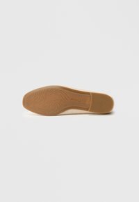 Light-colored shoe sole with a waved pattern, textured rubber material, and a tapered shape, featuring a small logo near the heel area.