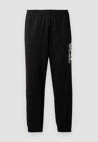 Pantalones deportivos negros de tela suave, con una cinturilla elástica y puños, y un logotipo en contraste impreso en el lado.
