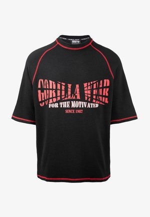 Zwarte kortemouwen shirt met rode accenten en geribbelde structuur. Heeft een uitdagende "Gorilla Wear" graphic en slogan in veroudere lettertype.