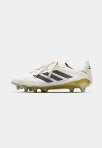 White soccer cleat with black accents, featuring a textured design, lace-up closure, a yellow sole, and multiple studs for traction.