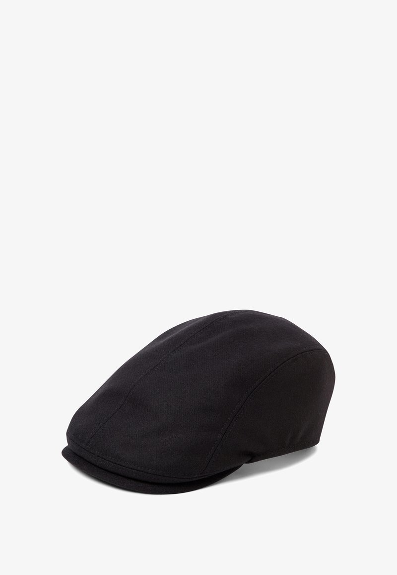 Black cap made of textured fabric, featuring a rounded crown and a short, stiff brim. Seam details are visible along the sides.