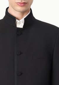 Black jacket with a high collar, featuring two fabric-covered buttons and a single chest pocket. Smooth texture with a tailored fit.
