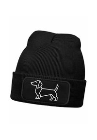 Black knitted beanie featuring a white line-drawn dachshund design on a rectangular patch, with a textured ribbed pattern throughout.