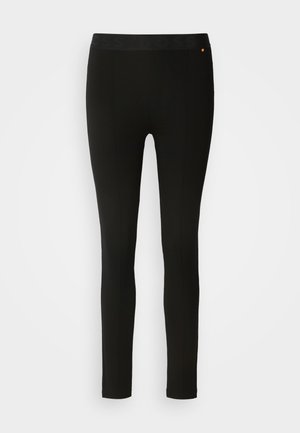 Black leggings with a smooth texture, featuring a flexible waistband and subtle seam detailing. No patterns or hardware present.