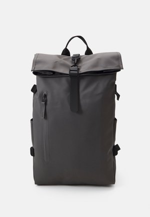 Gray waterproof roll-top backpack with adjustable straps, zipper pocket, and a front buckle closure. Smooth texture, minimalist design.